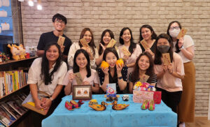 Group photo of Korean language students and qualified teacher celebrating the Chuseok cultural event, fostering a friendly classroom environment for learning.
