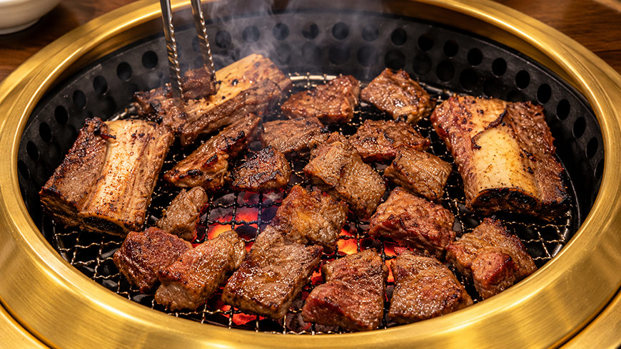 suwon-wanggalbi-beef-ribs Suwon wanggalbi beef ribs grilling over a Korean barbecue
